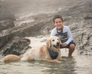 boy-and-dog-playing-in-the-rock-pools