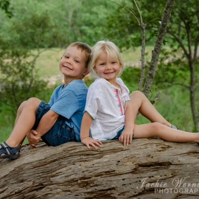 young-siblings-on-log
